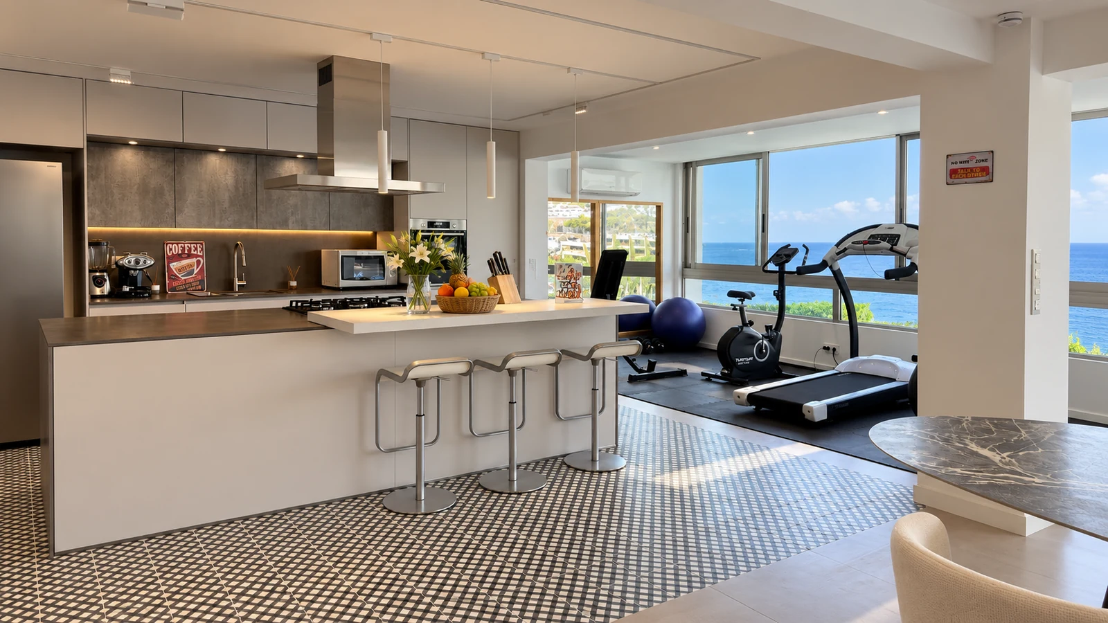 Kitchen island with bar stools and gym equipment on the lower level of Villa White Octopus