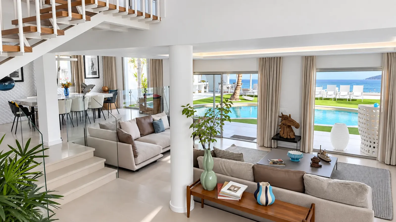 Living and dining area with staircase and pool view at Villa White Octopus, Tenerife