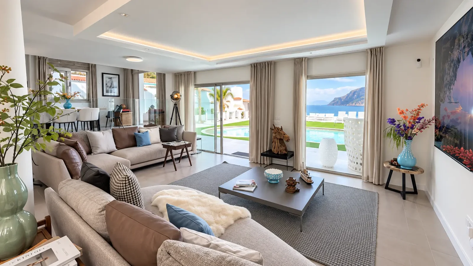Open-plan living room with sofas and Atlantic Ocean view at Villa White Octopus