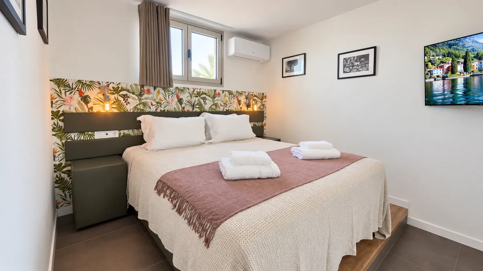 Bedroom with floral accent wall and television at Villa White Octopus, Tenerife