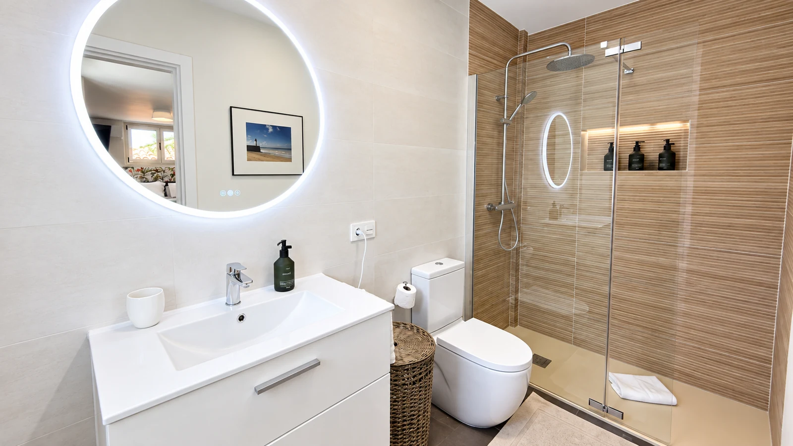 Bathroom with illuminated round mirror and vanity at Villa White Octopus