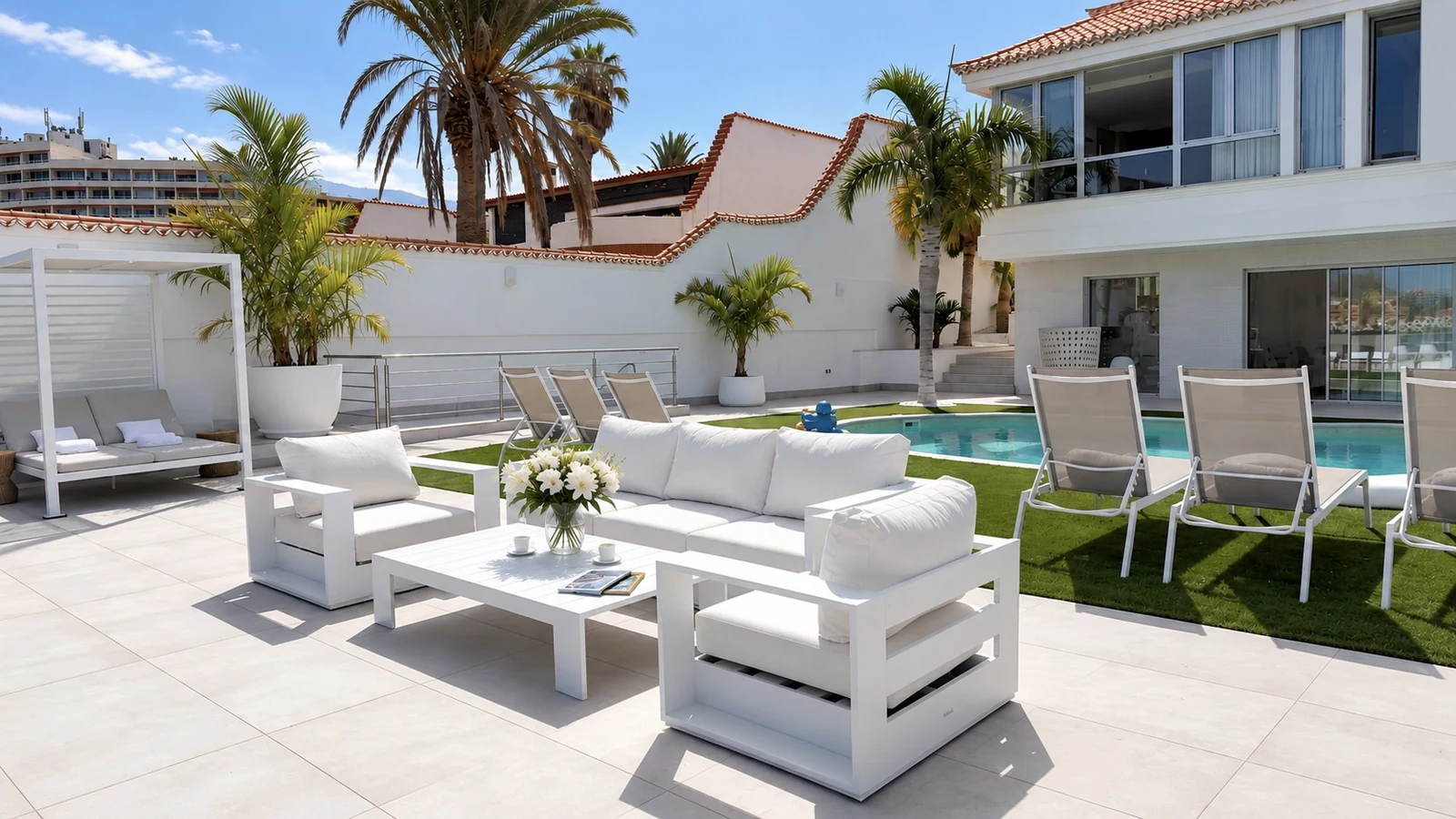 Terrace seating with flowers next to the private pool at Villa White Octopus
