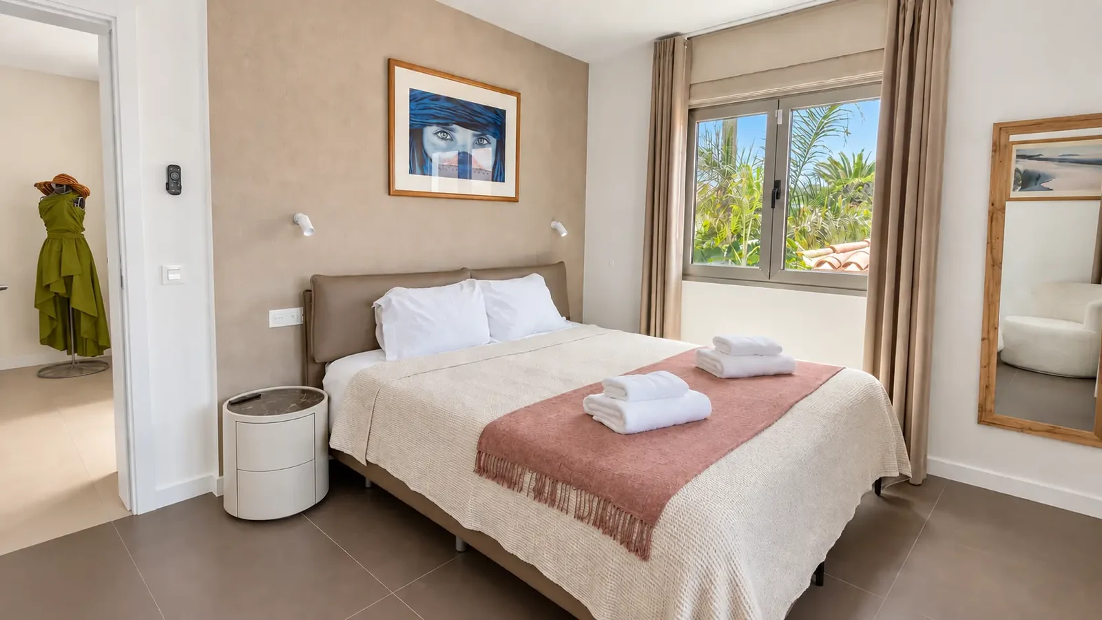 Bedroom with neutral bedding and tropical garden view at Villa White Octopus